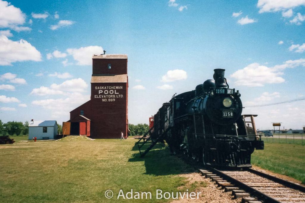 CN 1158 and grain elevator in North Battleford, SK, July 2003. Contributed by Adam Bouvier.