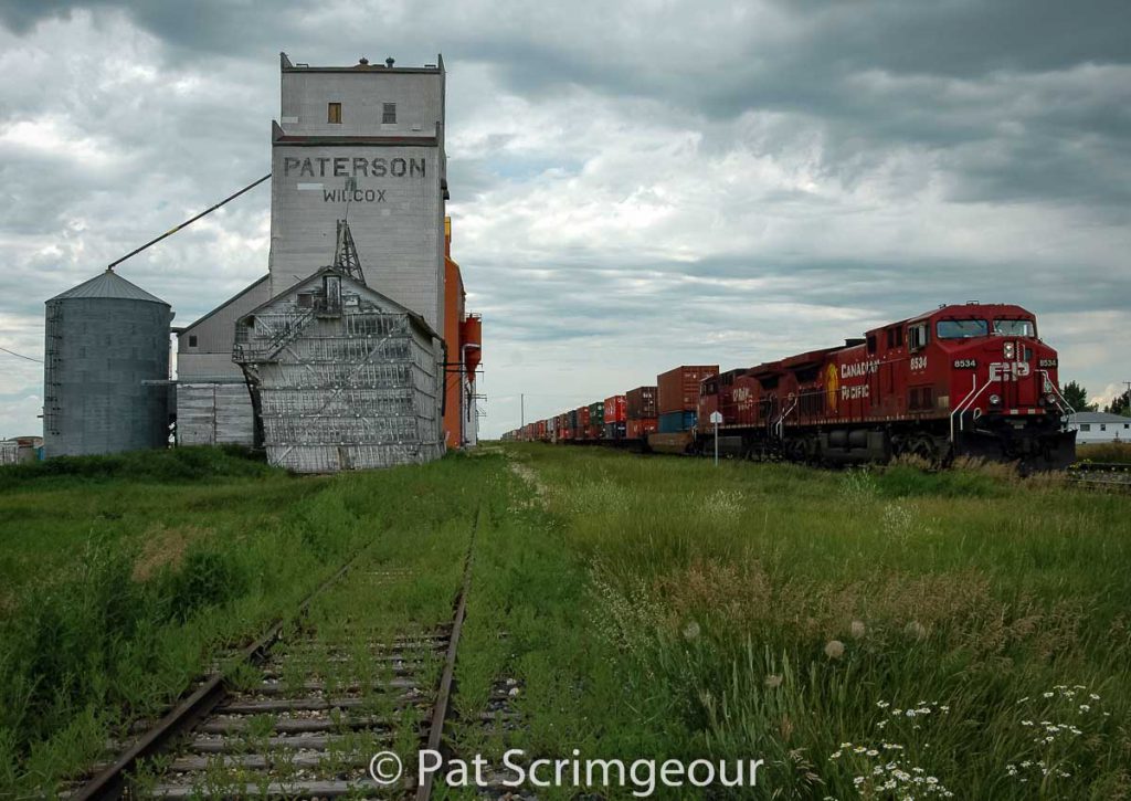 Train and grain elevators in Wilcox, SK, July 2005. Contributed by Pat Scrimgeour.