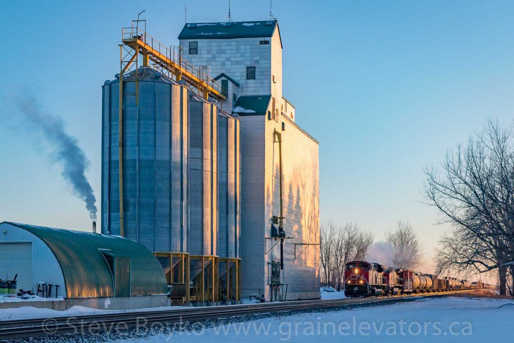 CN 8953 passes the Oakville, MB grain elevator, Dec 2017. Contributed by Steve Boyko.