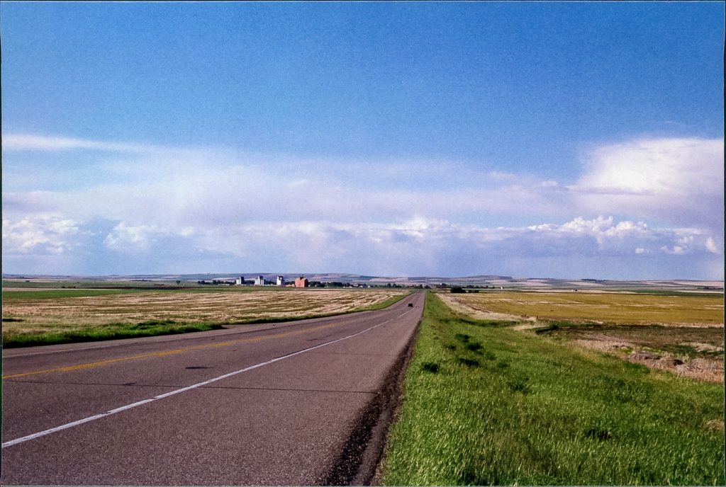 The road to Champion and its grain elevators, June 1999. Copyright by Robert Boyd.