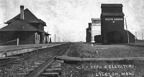 Lyleton, MB grain elevators and train station, circa 1910.
