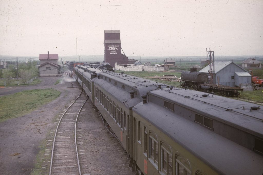 Wakaw, SK grain elevator and train, 1940s, Everett Baker slide.