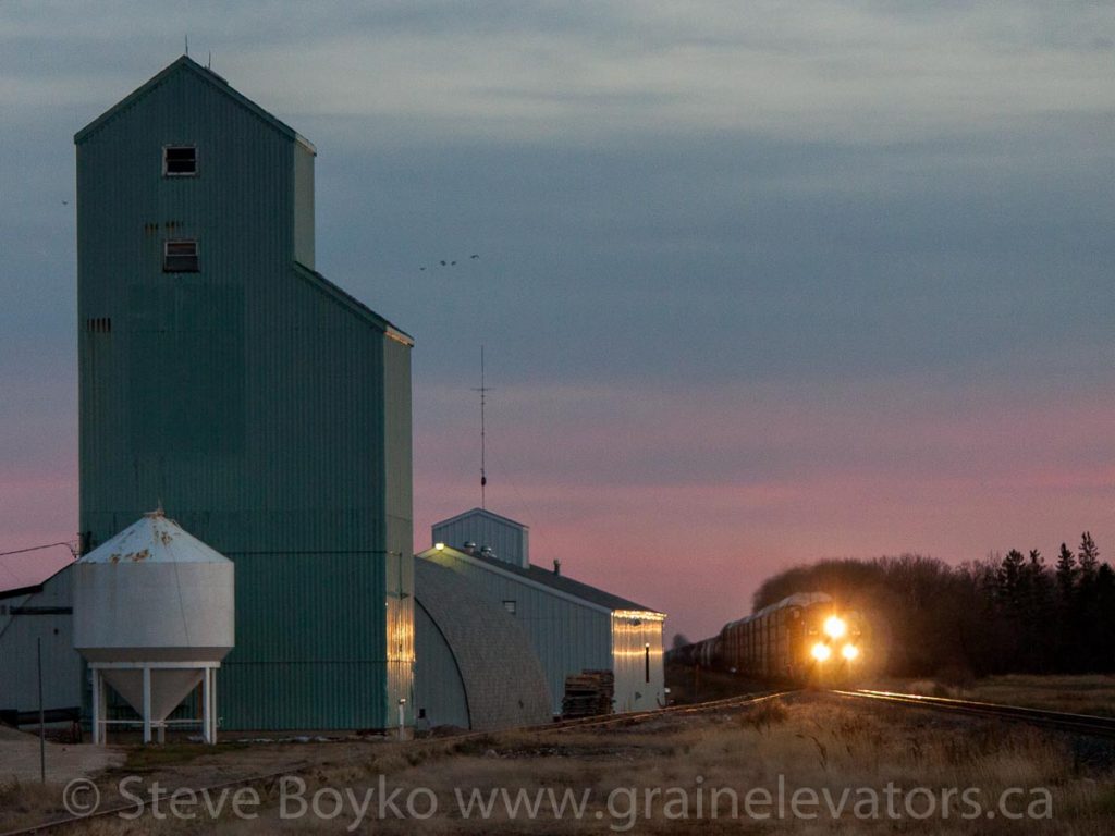 Train passing fertilizer elevator in Niverville, Oct 2012. Contributed by Steve Boyko.