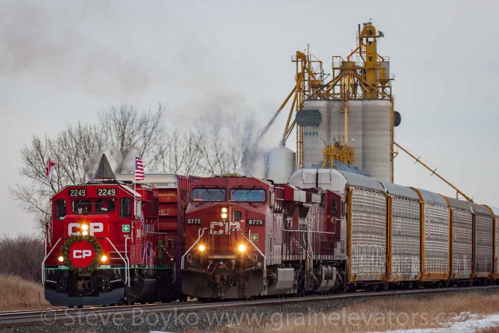 The CP Holiday Train passes a freight train at the Tucker grain elevator
