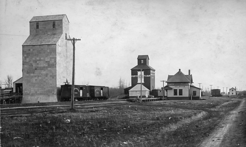 Kelwood, MB grain elevators and train station, date unknown.
