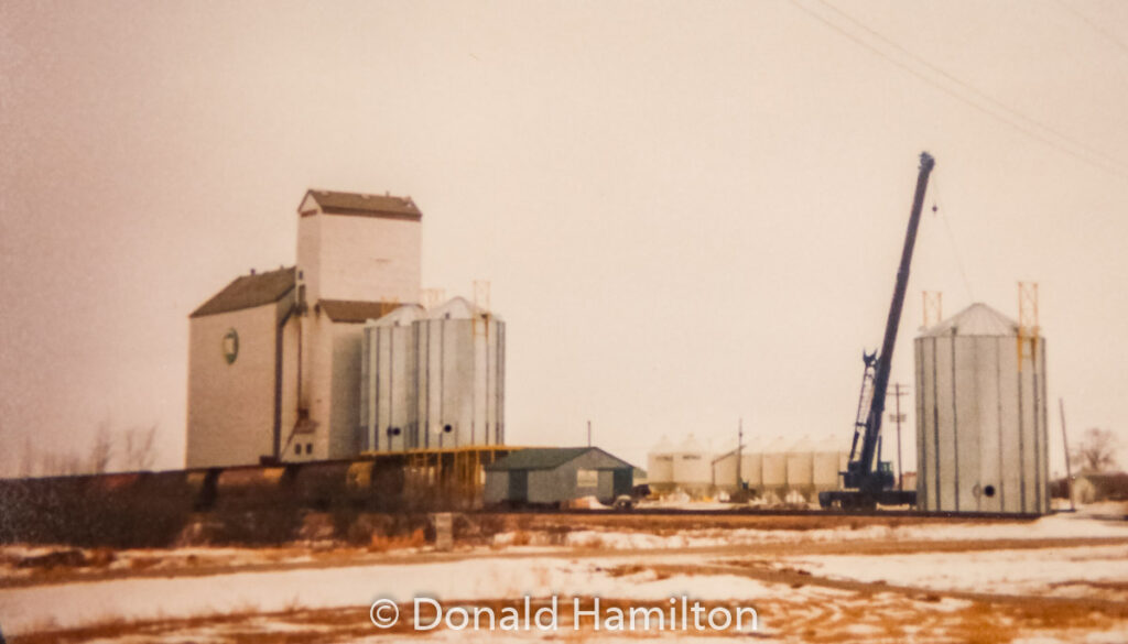 Westeel Bins being added by Litz Crane, Solsgirth, MB Feb 1991. Contributed by Donald Hamilton.