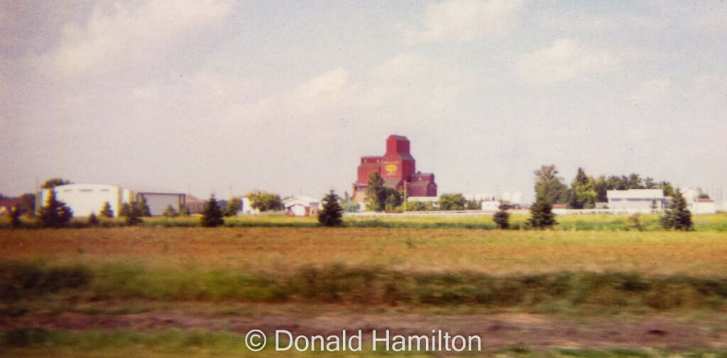 Passing by the Beatty grain elevator, Aug 1994. Contributed by Donald Hamilton.