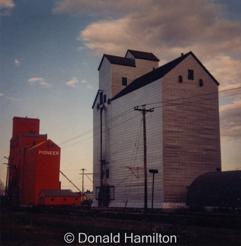 Brandon Pool "B" elevator and Pioneer grain elevator, June 1994. Copyright by Donald Hamilton.