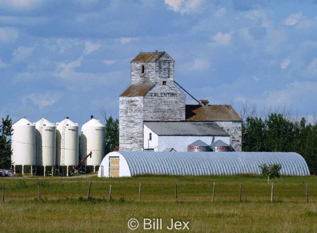 Valentine, AB grain elevator moved to a farm, July 2014. Contributed by Bill Jex.