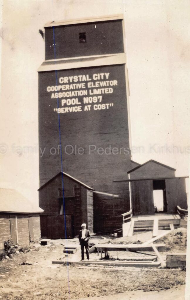 Black and white image of a grain elevator with the words "CRYSTAL CITY" on it.