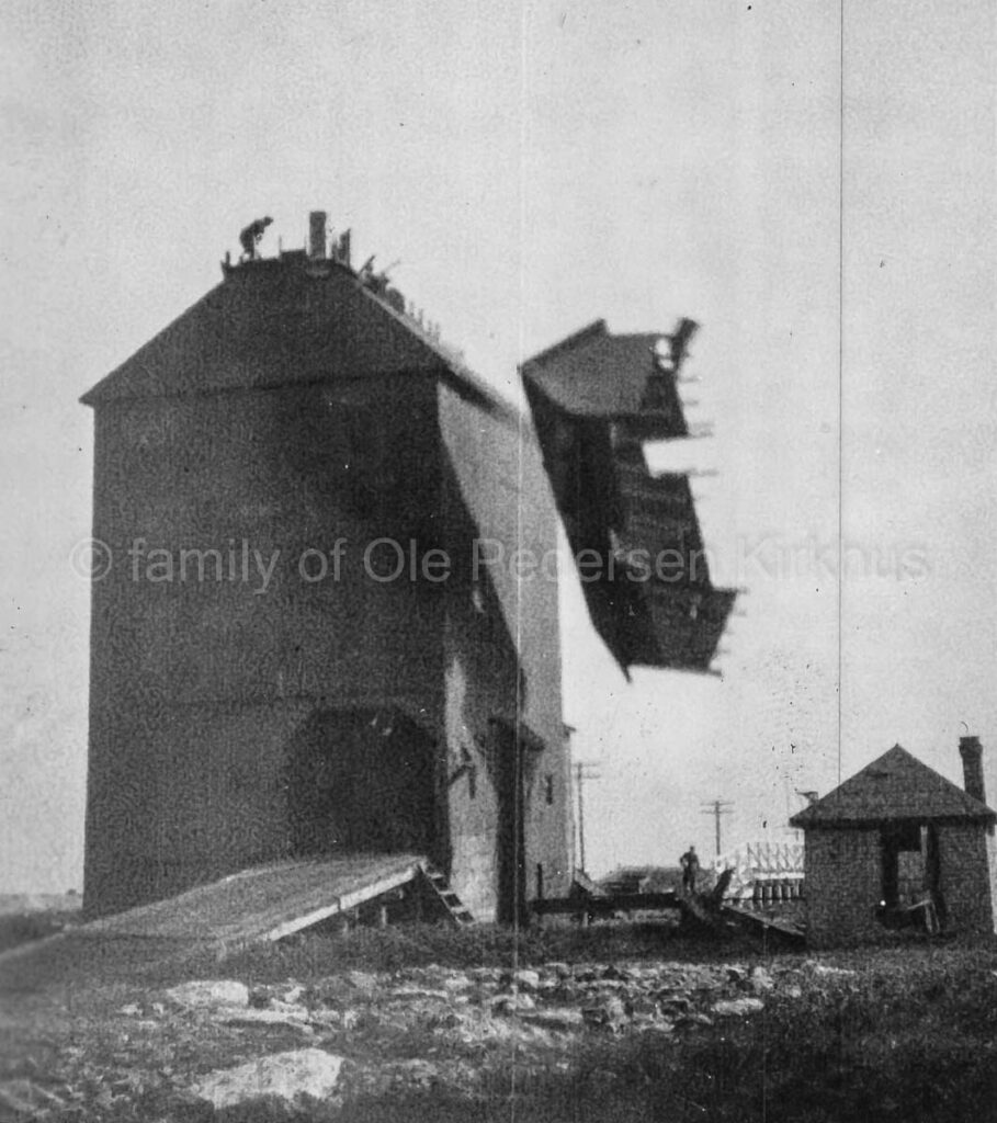 Demolition of a grain elevator in Gilbert Plains, 1927 or 1928. Contributed by the family of Ole Pedersen Kirkhus.