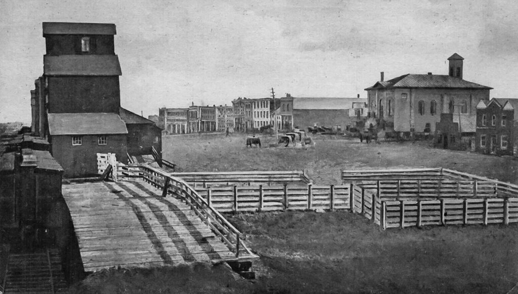 Grain elevator and stockyard in Wapella, SK, date unknown