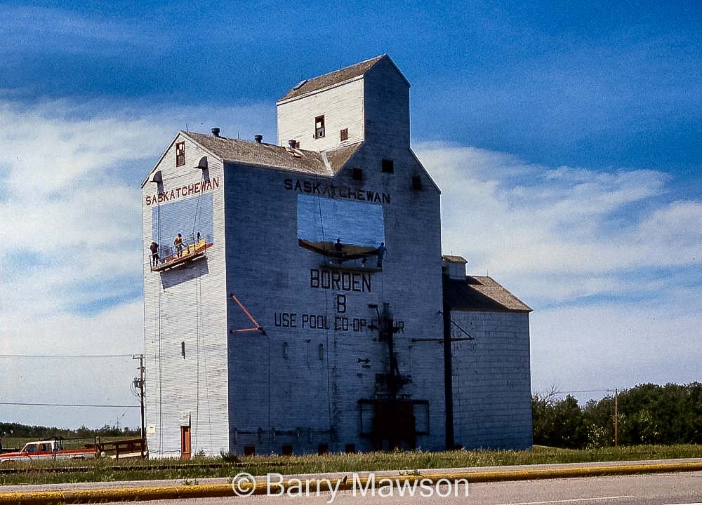 Painting over the Sask Wheat Pool logos, Borden "B" elevator. Contributed by Barry Mawson.