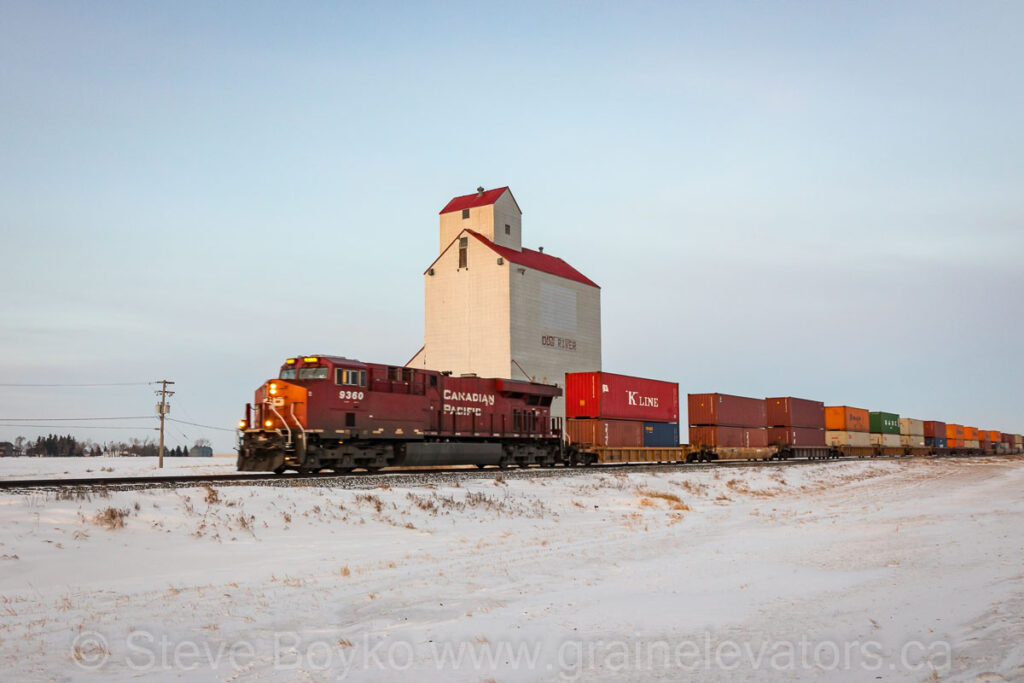Train passing the "Dog River" grain elevator. Contributed by Steve Boyko.