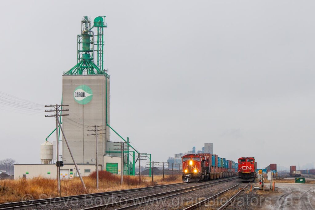 Two trains by the Cargill grain elevator in Transcona in Winnipeg, Manitoba.