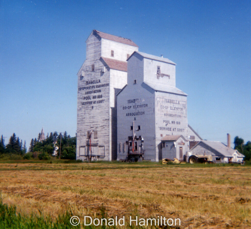 Paired wooden grain elevators