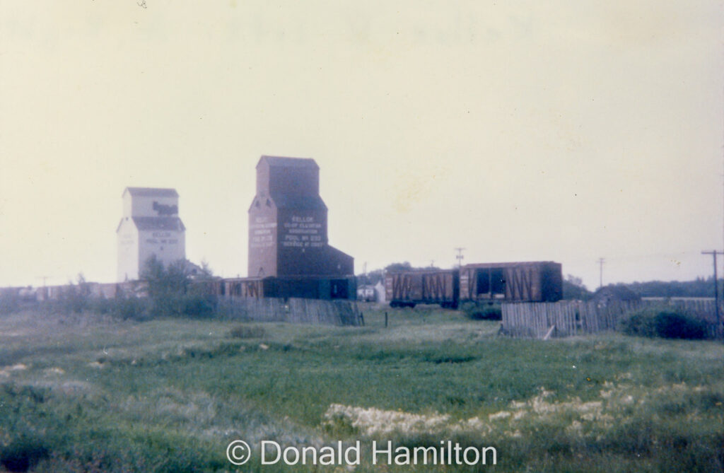 Two grain elevators and rail cars