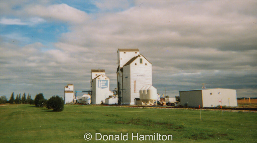 Line of three wooden grain elevators