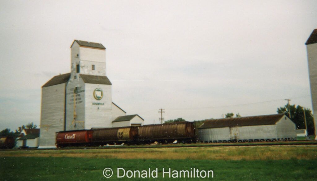 Wooden grain elevator and rail cars