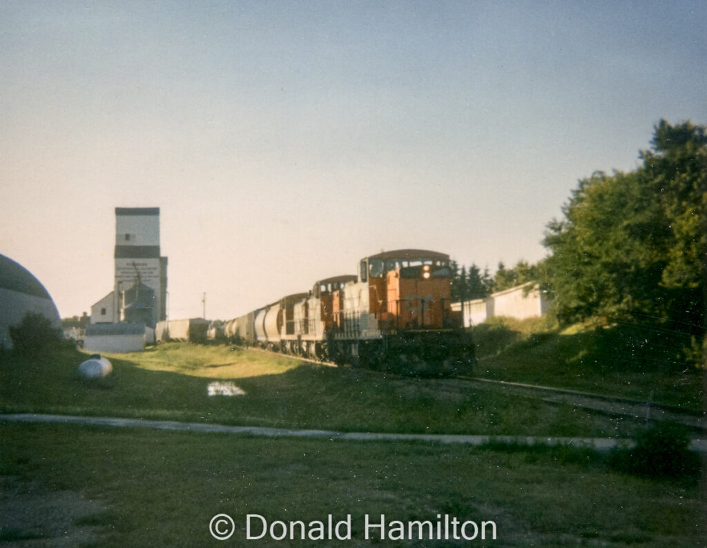 CN train switching the grain elevators in Rossburn, MB, July 1991