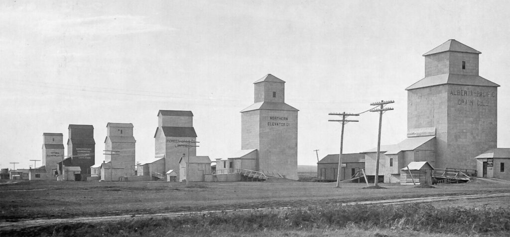 Six grain elevators in Hazenmore, SK, 1927.