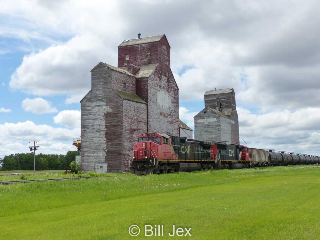 CN train passing grain elevators in Waseca, SK, June 2022. Contributed by Bill Jex.
