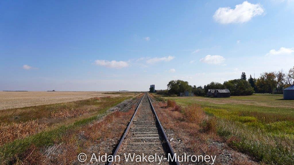 Railway track receding from view on the open prairie