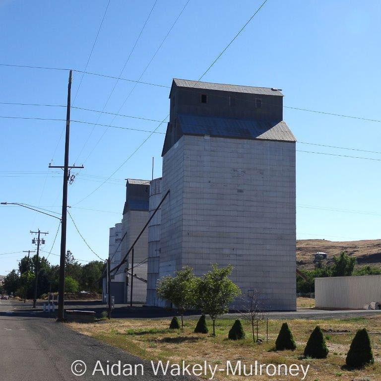 Two grain elevators on a street in Washtucna Washington