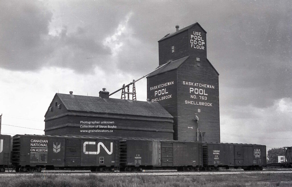 Wooden grain elevator with grain boxcars
